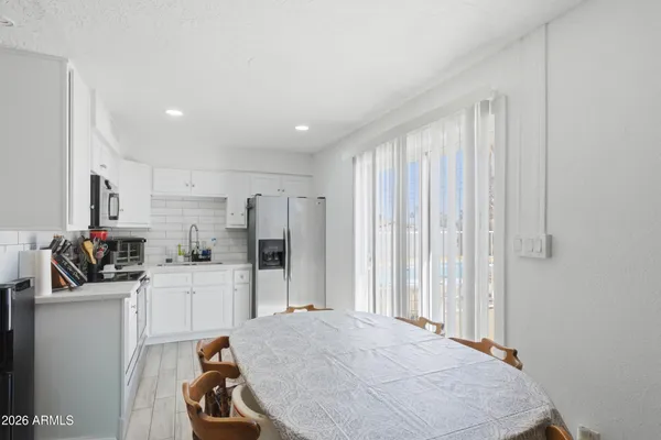 a kitchen with refrigerator and cabinets