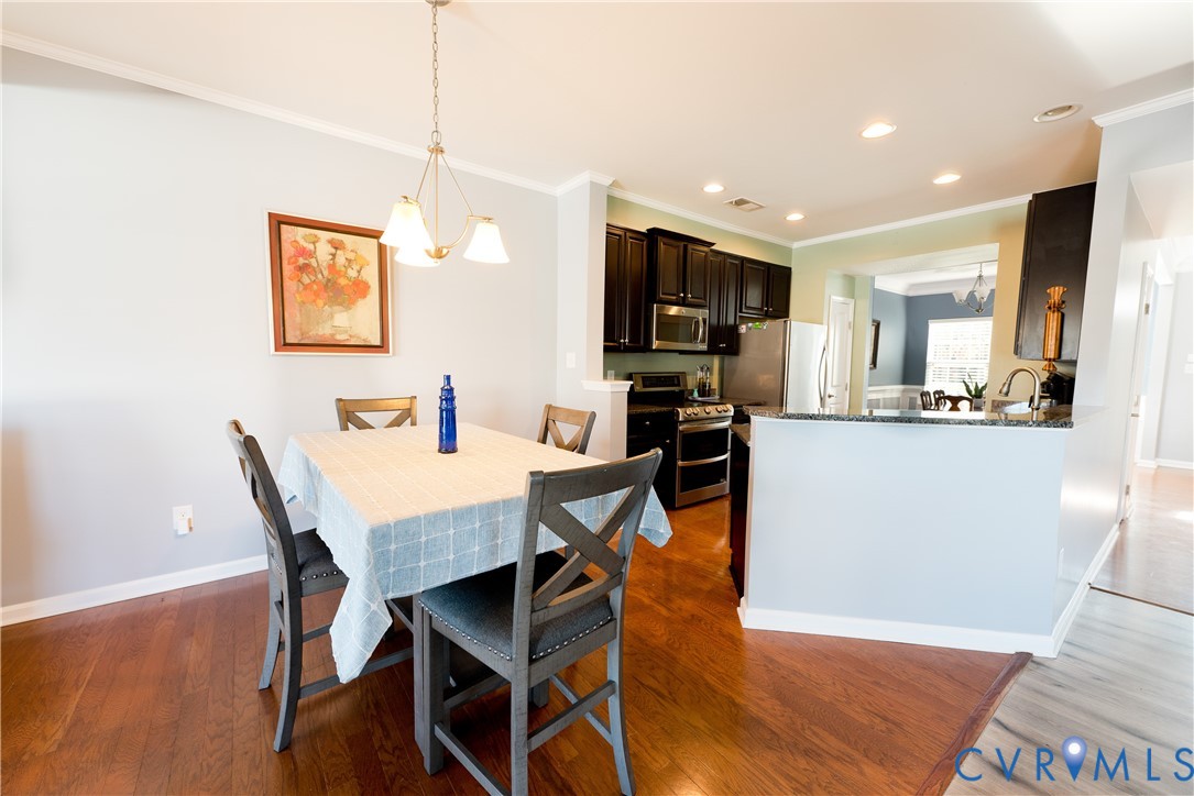 10343 Colony Bee Place Mechanicsville, VA 23116 - Photo 11 of 50 a dining room with kitchen island a table and chairs