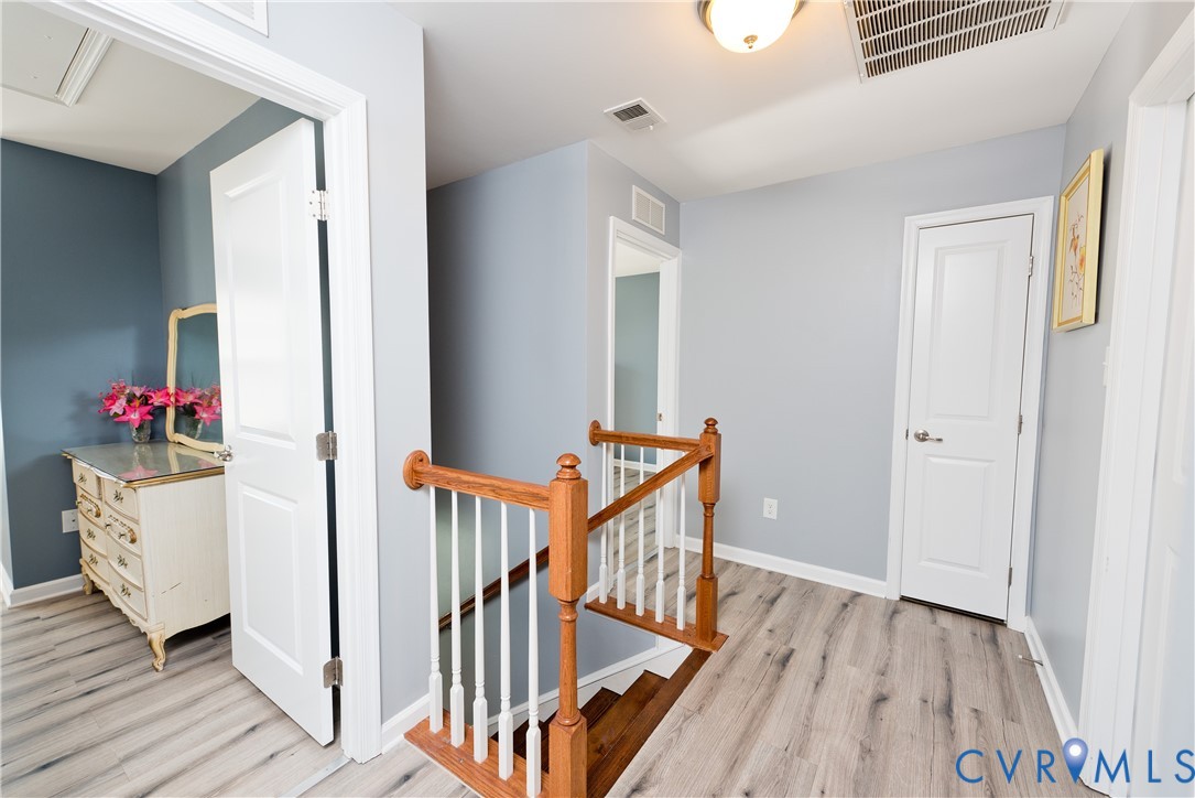 10343 Colony Bee Place Mechanicsville, VA 23116 - Photo 17 of 50 a view of a hallway with wooden floor and staircase