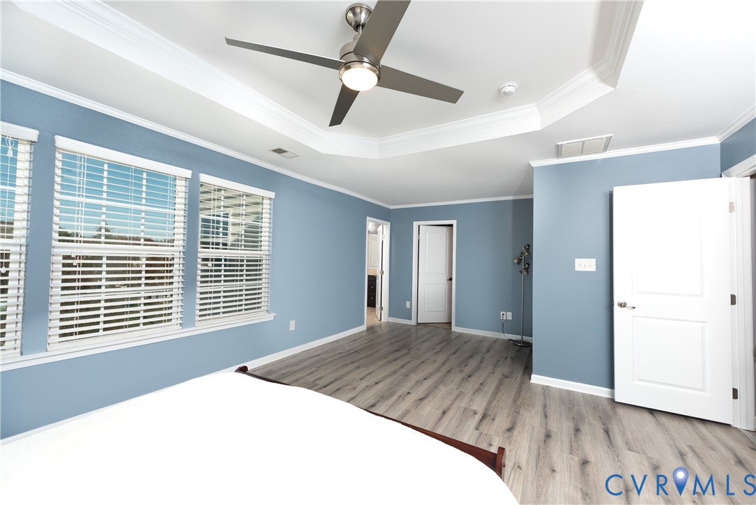 10343 Colony Bee Place Mechanicsville, VA 23116 - Photo 20 of 50 a bedroom with a large bed window and wooden floor
