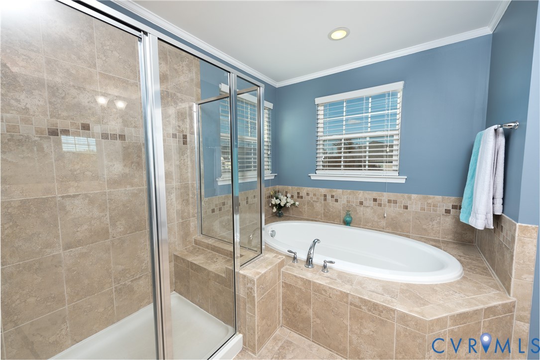10343 Colony Bee Place Mechanicsville, VA 23116 - Photo 21 of 50 a white bath tub sitting next to a shower