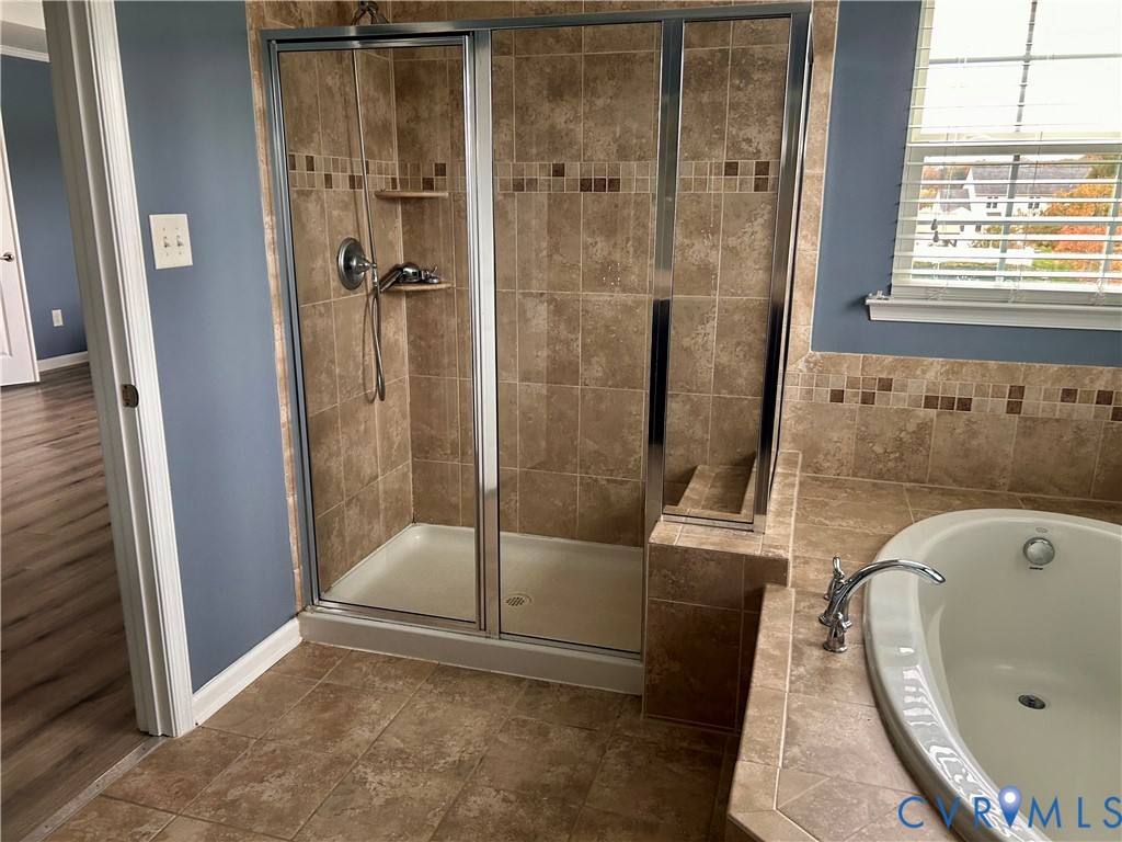 10343 Colony Bee Place Mechanicsville, VA 23116 - Photo 22 of 50 a bathroom with a tub and a shower