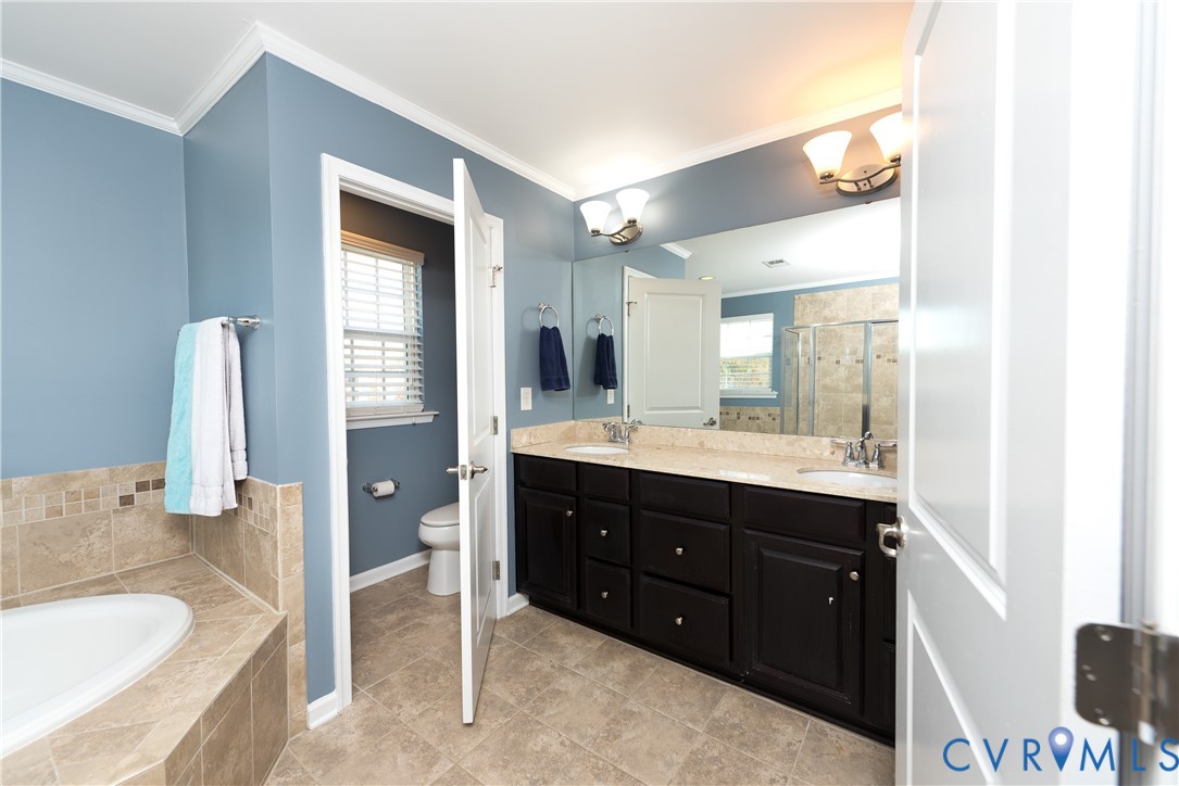 10343 Colony Bee Place Mechanicsville, VA 23116 - Photo 23 of 50 a spacious bathroom with a tub sink and mirror