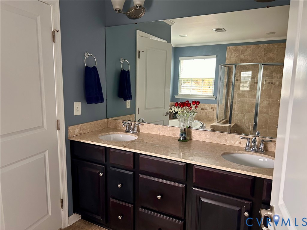 10343 Colony Bee Place Mechanicsville, VA 23116 - Photo 24 of 50 a bathroom with a sink and a mirror