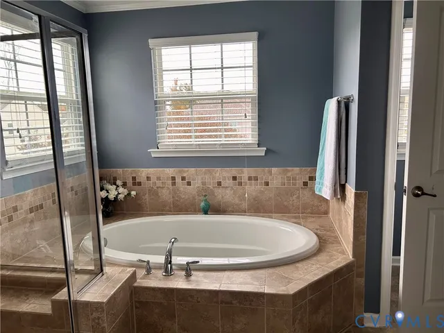 an aerial view of a house with a yard and lake view