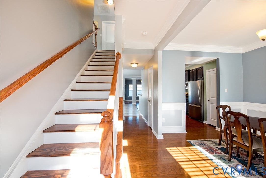 10343 Colony Bee Place Mechanicsville, VA 23116 - Photo 5 of 50 a view of a hallway with wooden floor and staircase