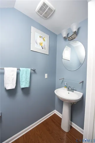 a living room with stainless steel appliances furniture a fireplace a flat screen tv and kitchen view