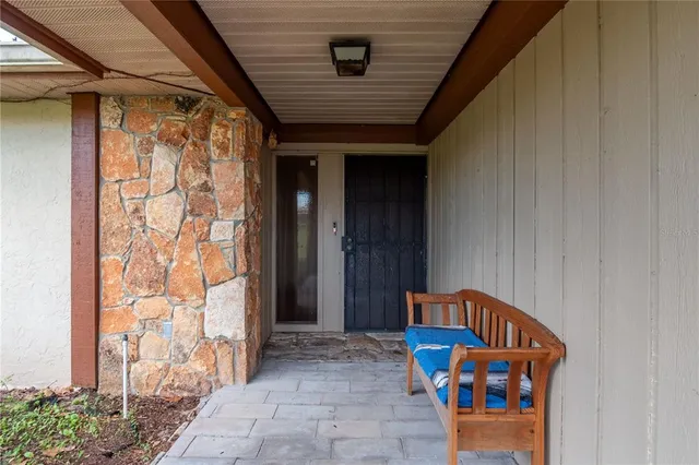 an empty room with windows and fireplace