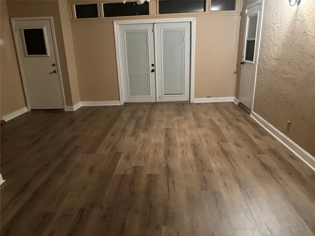 a view of hallway with wooden floor