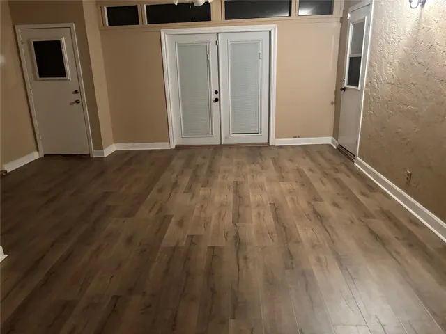 a view of hallway with wooden floor