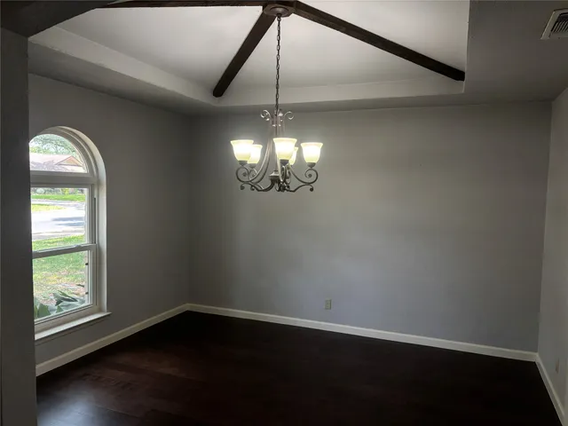 a room with window wooden floor and a ceiling fan