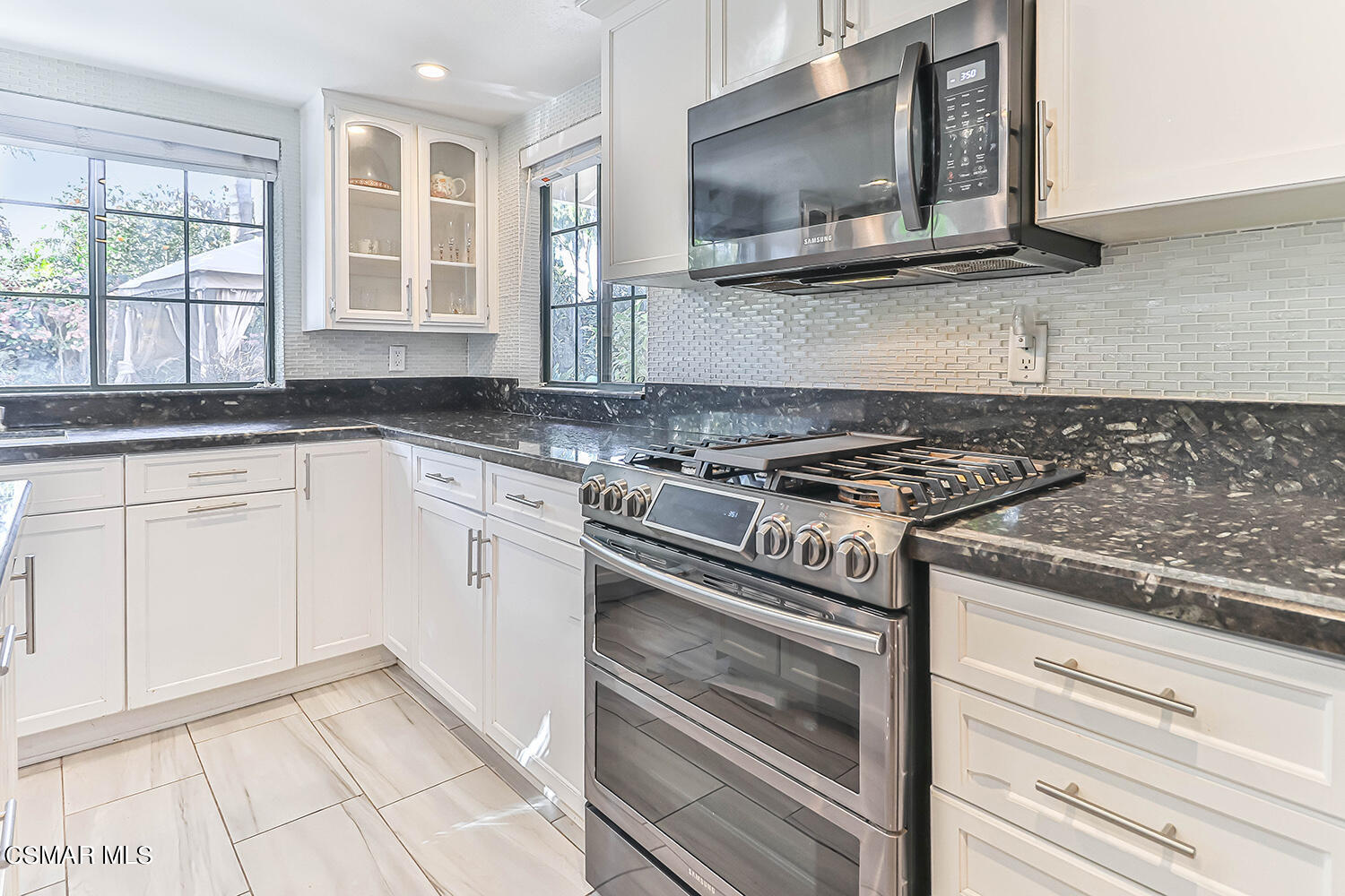 2911 Fanshell Walk Oxnard, CA 93035 - Photo 12 of 42 a kitchen with granite countertop a stove microwave and sink