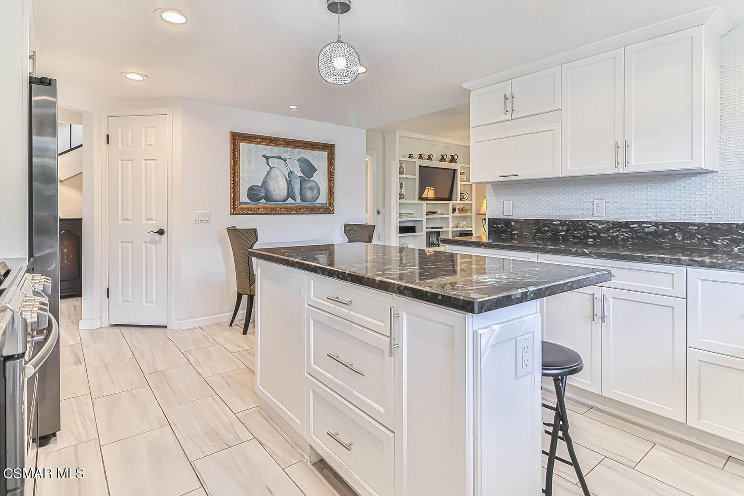 2911 Fanshell Walk Oxnard, CA 93035 - Photo 14 of 42 a kitchen with granite countertop a sink and a stove top oven