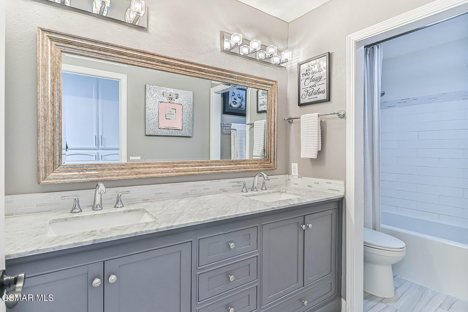 2911 Fanshell Walk Oxnard, CA 93035 - Photo 31 of 42 a bathroom with a granite countertop sink a toilet and a mirror