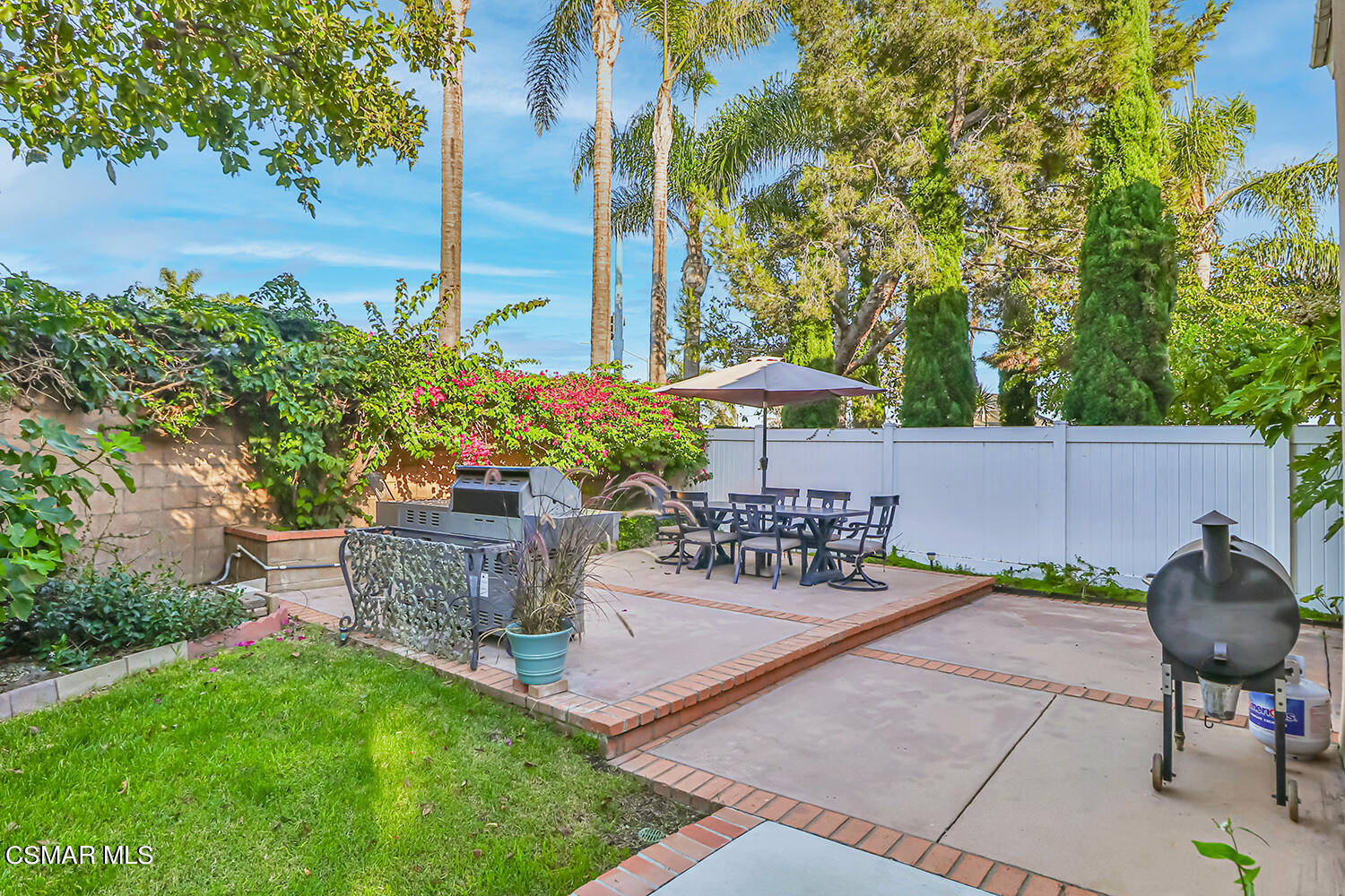 2911 Fanshell Walk Oxnard, CA 93035 - Photo 35 of 42 a view of a patio with table and chairs potted plants and a large tree