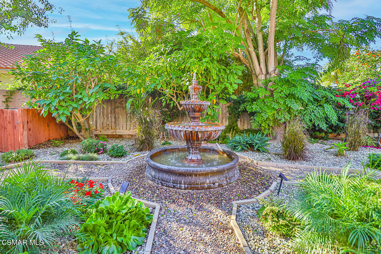 2911 Fanshell Walk Oxnard, CA 93035 - Photo 4 of 42 a front view of a house with a yard fountain and a tree