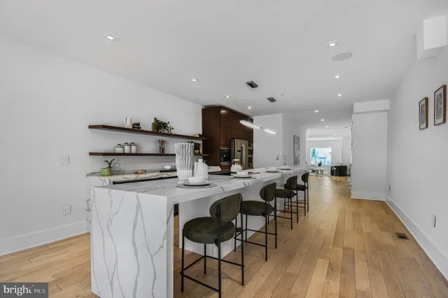 a large white kitchen with a lot of counter space
