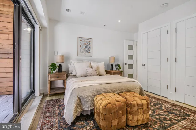 a bedroom with a large bed and a large window