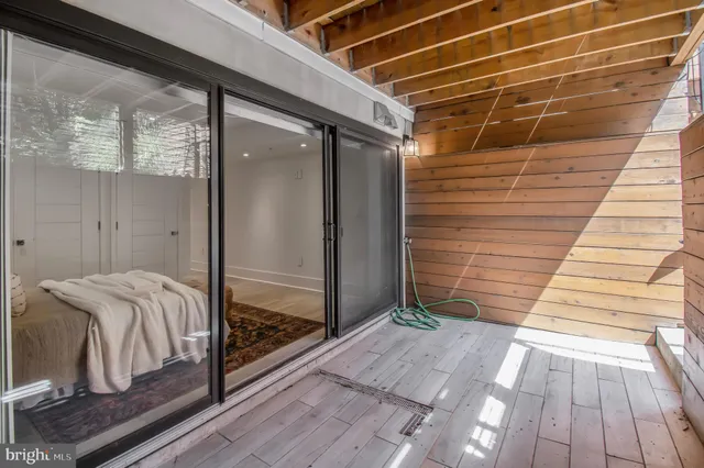 a view of a house with backyard and wooden fence