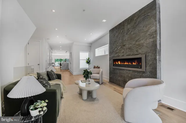 a living room with furniture a rug and a fireplace