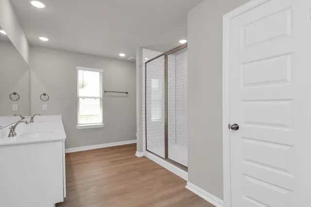 a bathroom with a double vanity sink and a mirror