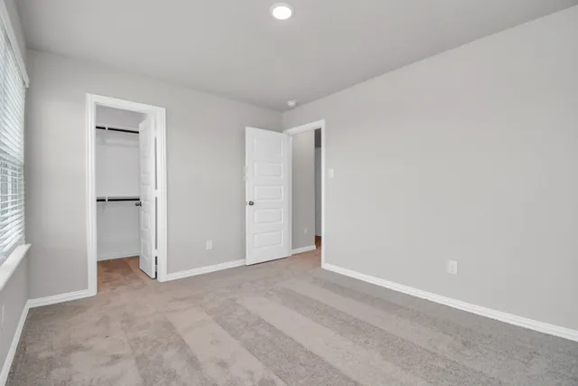 a bathroom with a bathtub shower sink vanity mirror and toilet