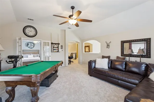 a living room with furniture and a clock