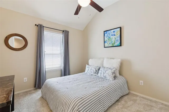 a bedroom with a bed and a painting on the wall