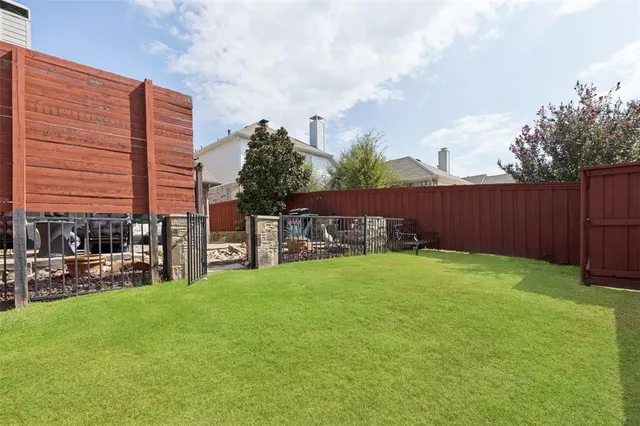 a backyard of a house with table and chairs