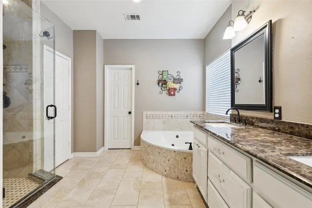 a bathroom with a tub sink and mirror