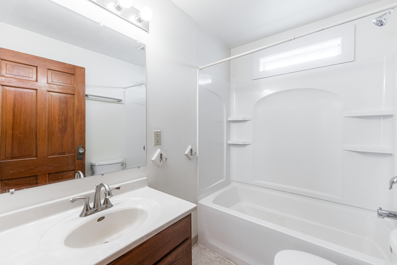 512 North 6th Street, Unit 1 DeKalb, IL 60115 - Photo 11 of 15 a bathroom with a sink a toilet and shower