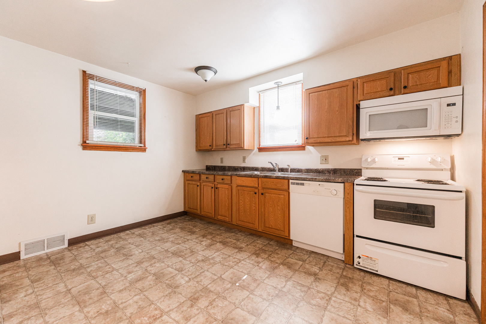 512 North 6th Street, Unit 1 DeKalb, IL 60115 - Photo 6 of 15 a kitchen with granite countertop a stove top oven and cabinets