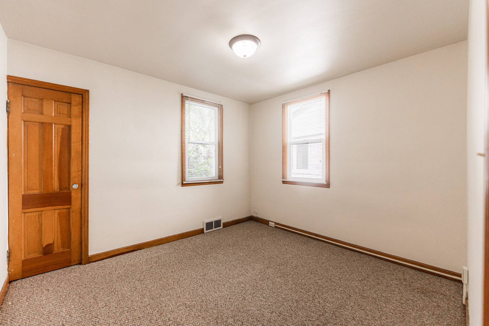 512 North 6th Street, Unit 1 DeKalb, IL 60115 - Photo 9 of 15 an empty room with windows