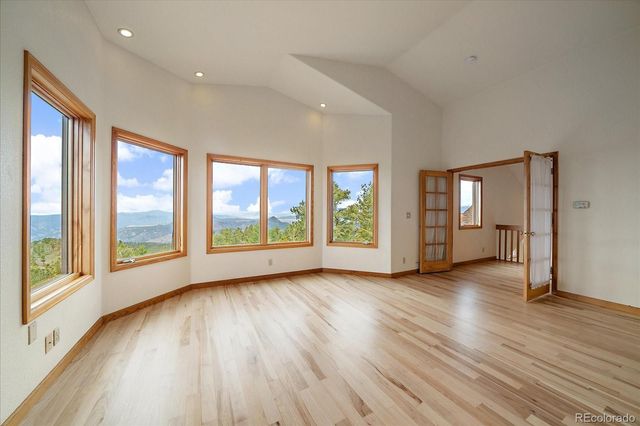 a living room with furniture a flat screen tv and a floor to ceiling window