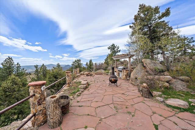 a view of a big house with a big yard and large trees