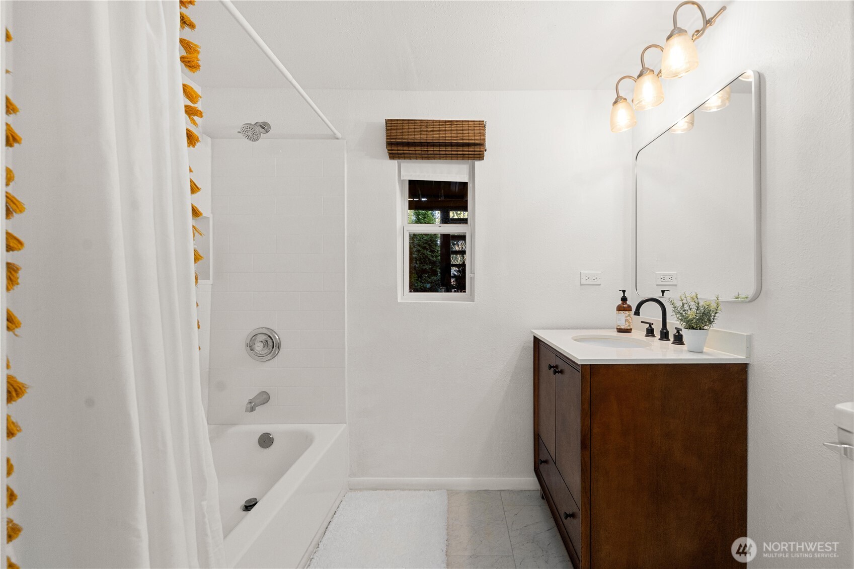 30024 2nd Avenue Southwest Federal Way, WA 98023 - Photo 28 of 40 a bathroom with a sink a mirror and a bathtub