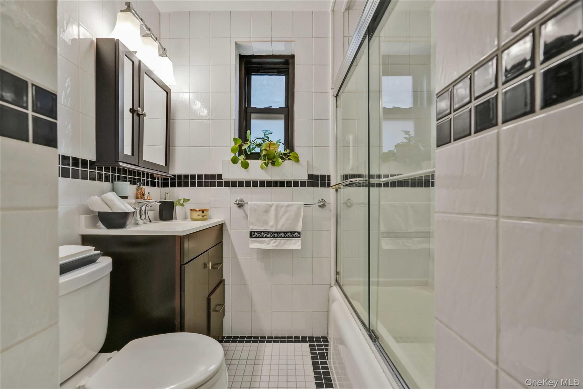 140-08 28th Road, Unit 1C Queens, NY 11354 - Photo 11 of 14 a bathroom with a sink toilet and shower