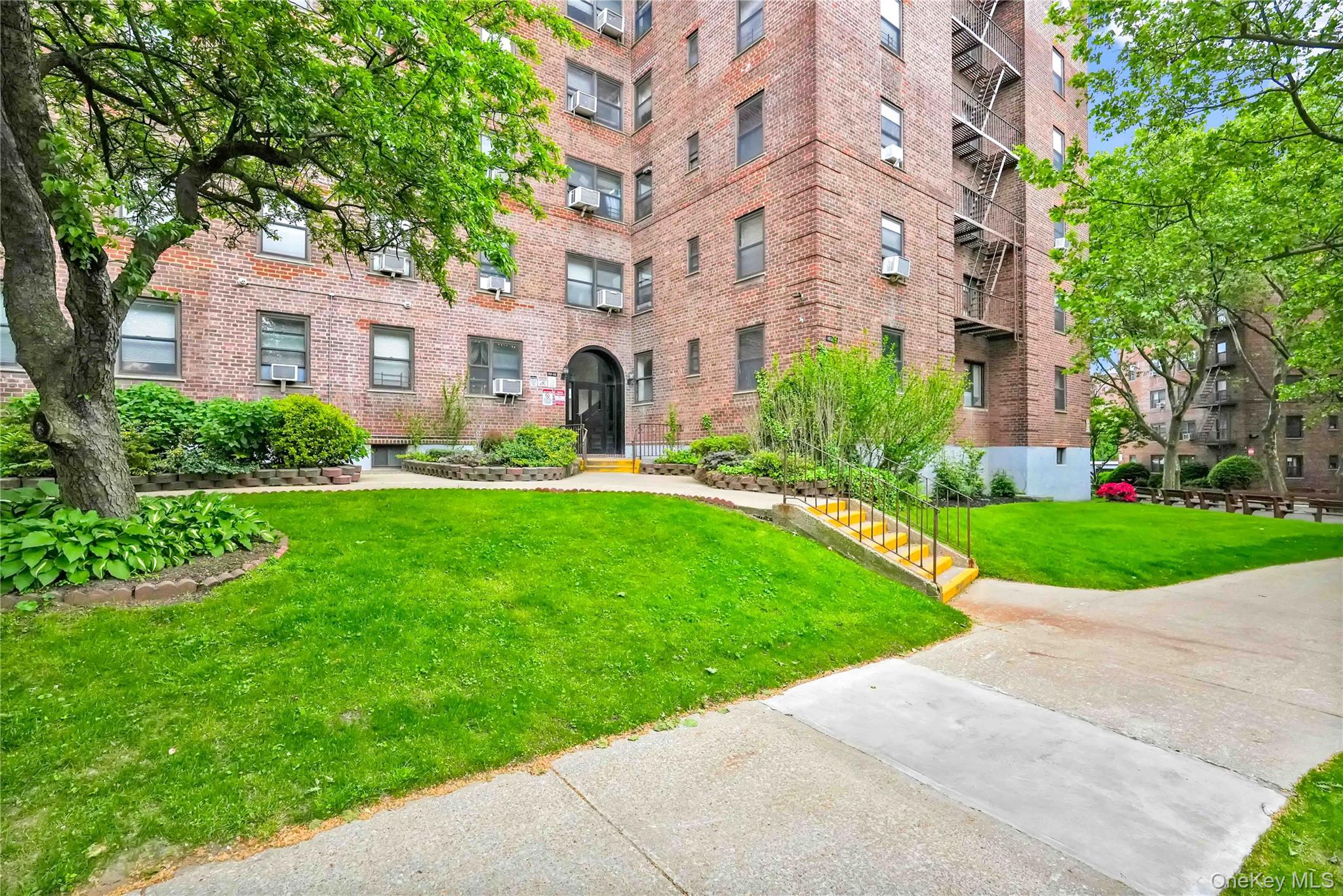 140-08 28th Road, Unit 1C Queens, NY 11354 - Photo 14 of 14 a front view of a building with garden