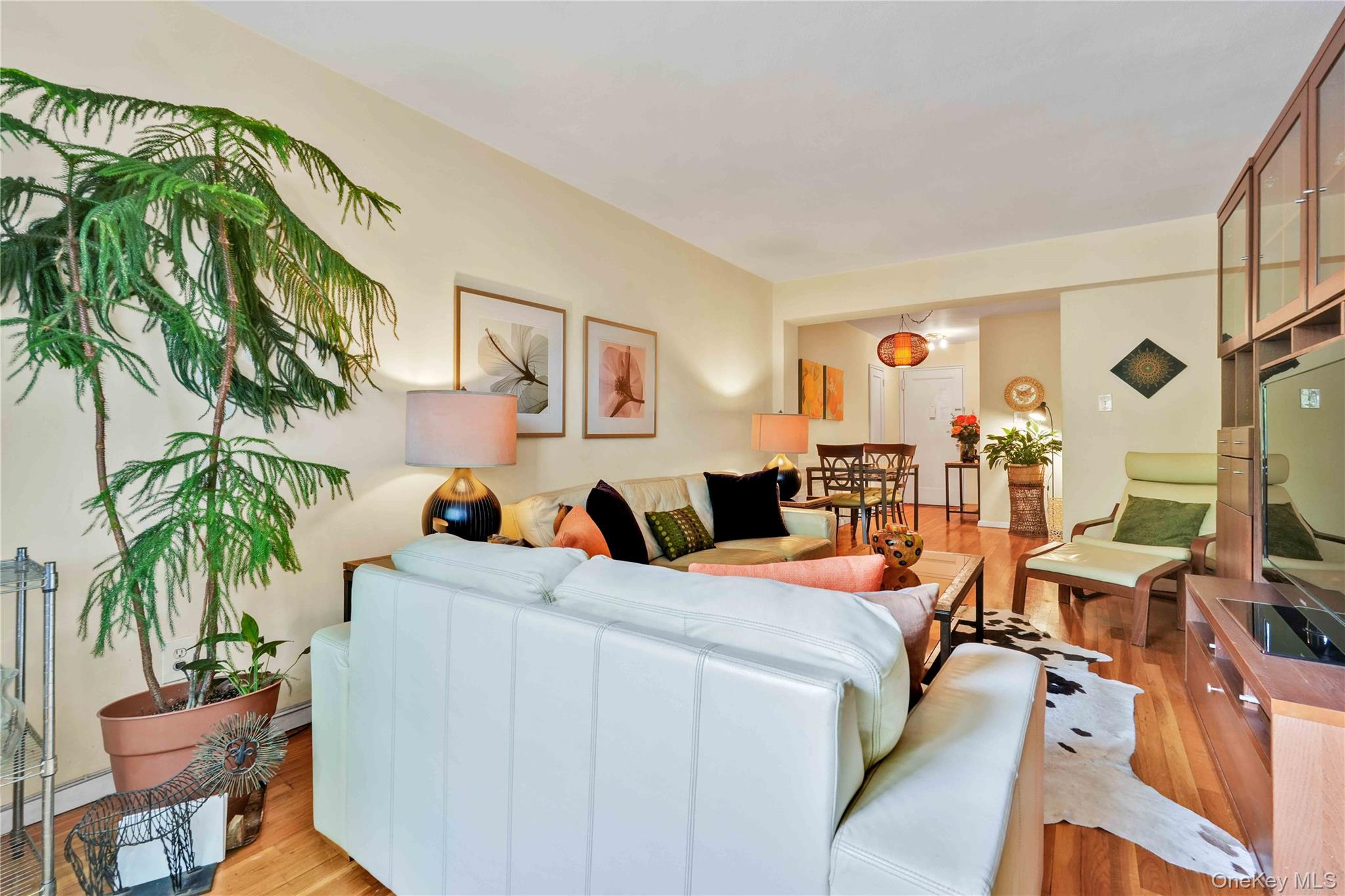 140-08 28th Road, Unit 1C Queens, NY 11354 - Photo 2 of 14 a room with furniture and a potted plant