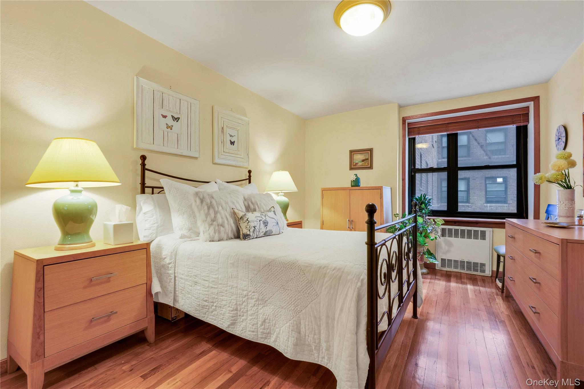 140-08 28th Road, Unit 1C Queens, NY 11354 - Photo 5 of 14 a bedroom with a bed and wooden floor