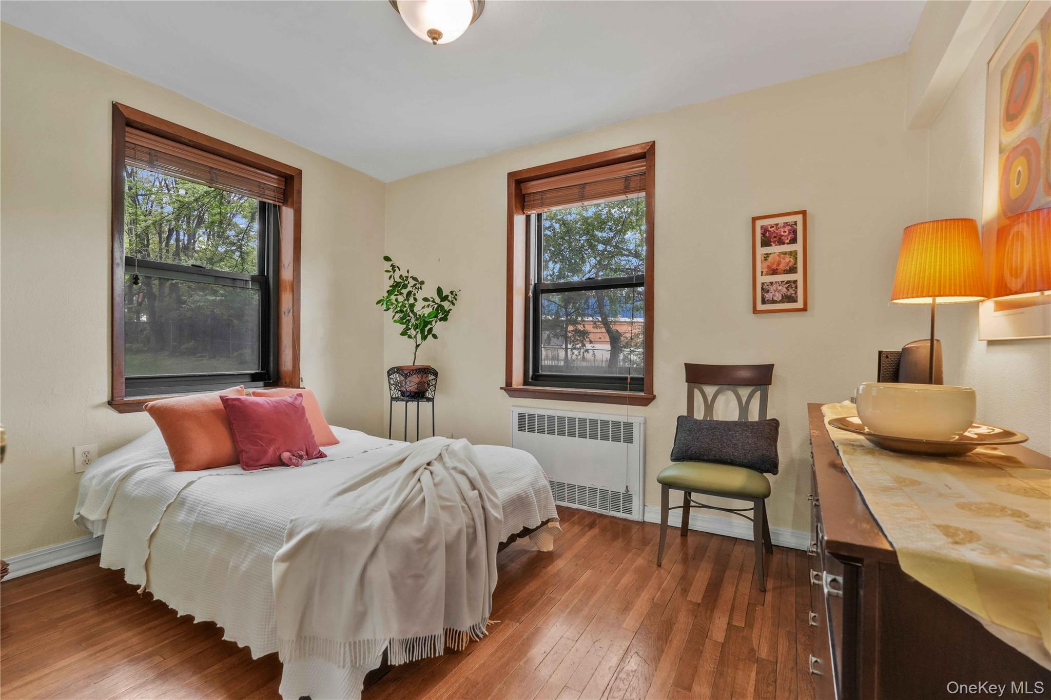 140-08 28th Road, Unit 1C Queens, NY 11354 - Photo 7 of 14 a bedroom with a bed and wooden floor