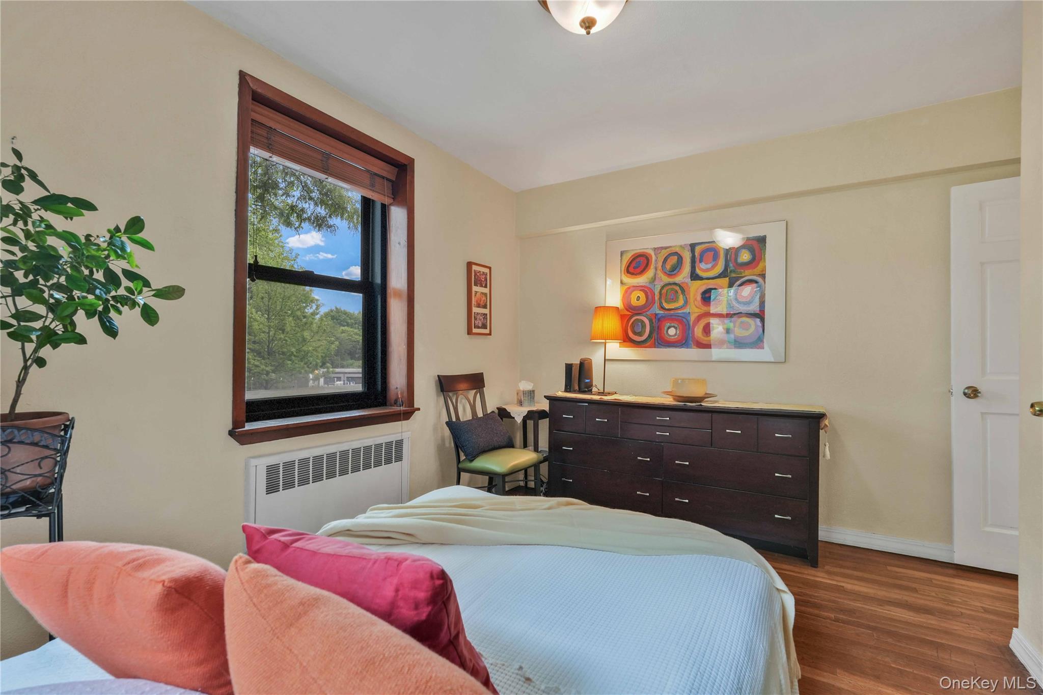 140-08 28th Road, Unit 1C Queens, NY 11354 - Photo 8 of 14 a bedroom with a bed and a window