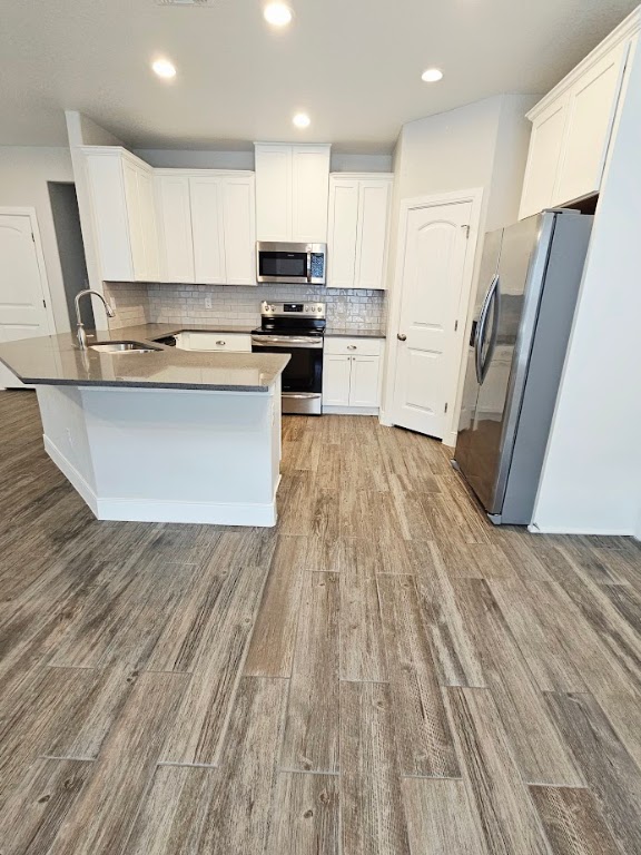 110 East Otto Street Marion, TX 78124 - Photo 4 of 14 a kitchen with wooden floors and appliances