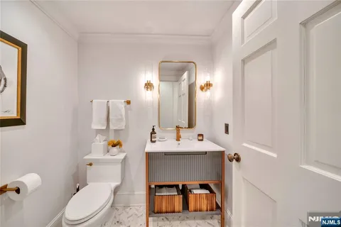 a bathroom with a sink toilet vanity and mirror