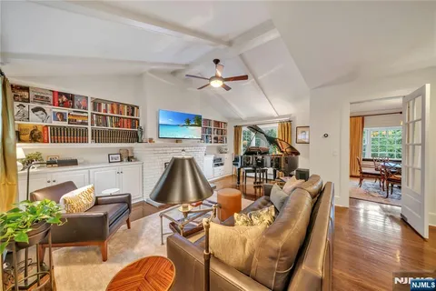 a living room filled with furniture hardwood floor and a table
