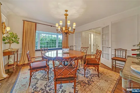 a view of a dining room with furniture wooden floor and a chandelier