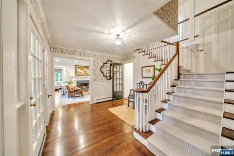 a view of entryway with wooden floor and a livingroom view