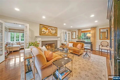 a living room with fireplace furniture and a table