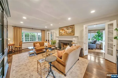 a living room with furniture large window and a fireplace
