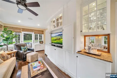 a living room with furniture tv and a large window